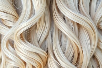 Gyönyörű szőke haj fürtjei, egészséges és fényes megjelenéssel.